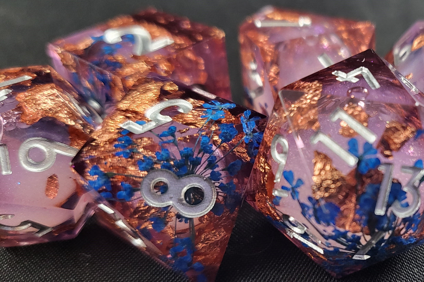 Closeup of a Liquid Core Dice Set with Blue Flowers and copper flakes ~ D&D, Pathfinder, other TTRPGs.